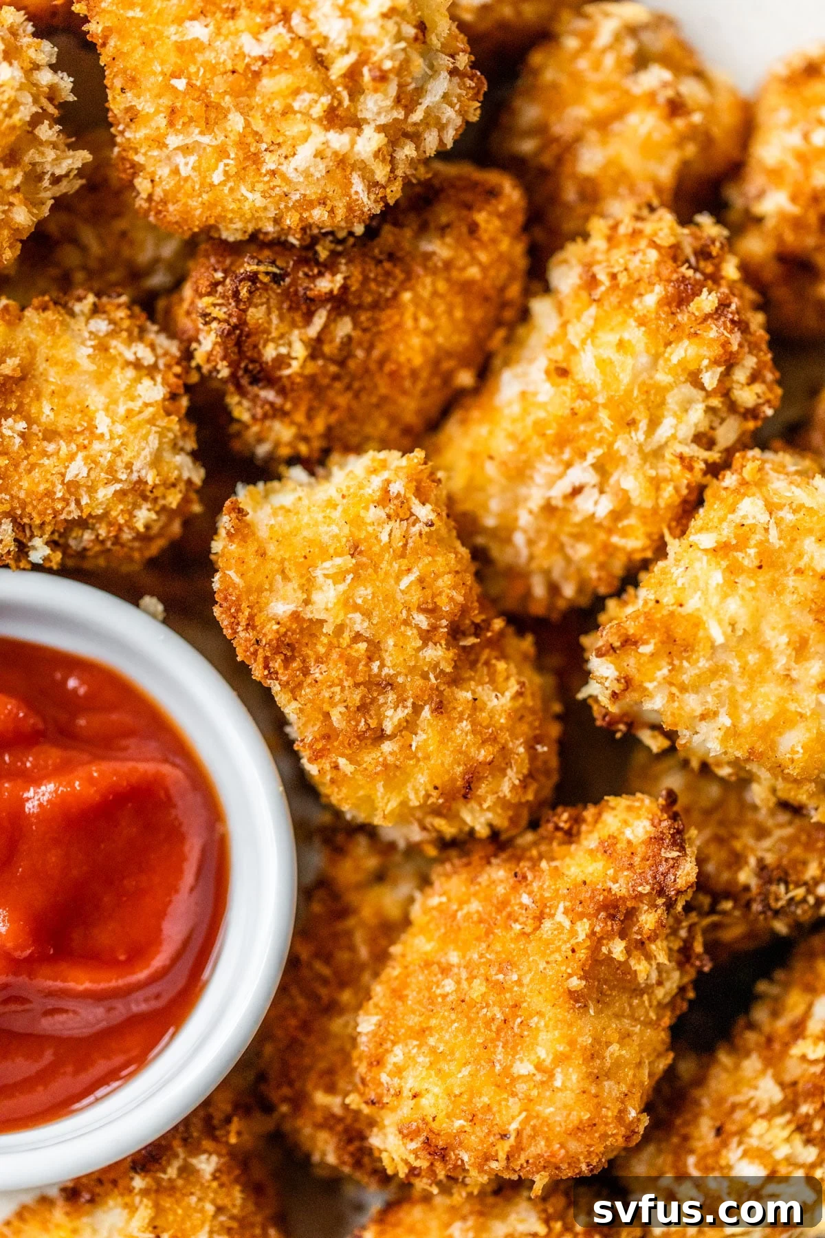 Crispy Air Fryer Chicken Nuggets served beside a small bowl of vibrant red ketchup