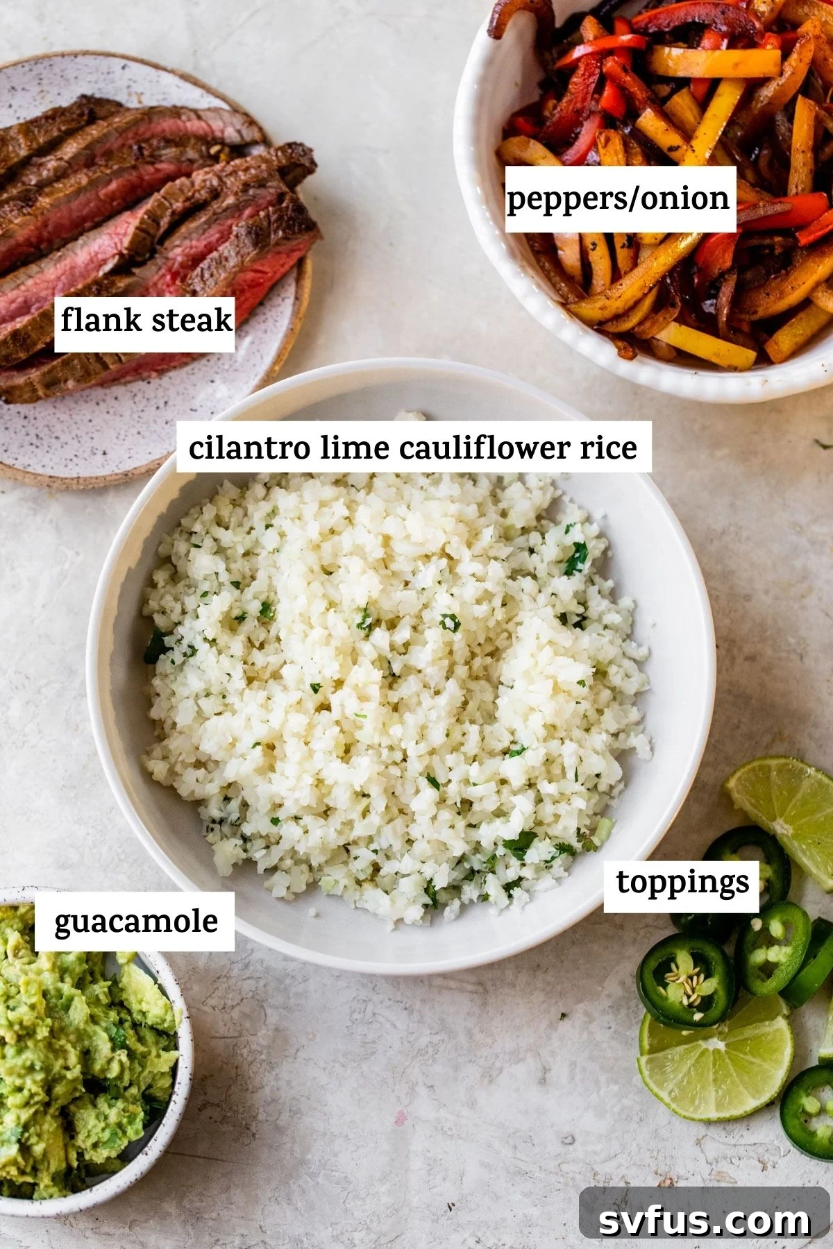 A spread of fresh ingredients laid out for making fajita bowls, including vibrant cauliflower rice, uncooked marinated steak, and colorful bell peppers, highlighting the wholesome components of the meal.