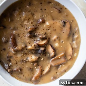 A bowl of creamy mushroom soup, elegantly presented and ready to be served.