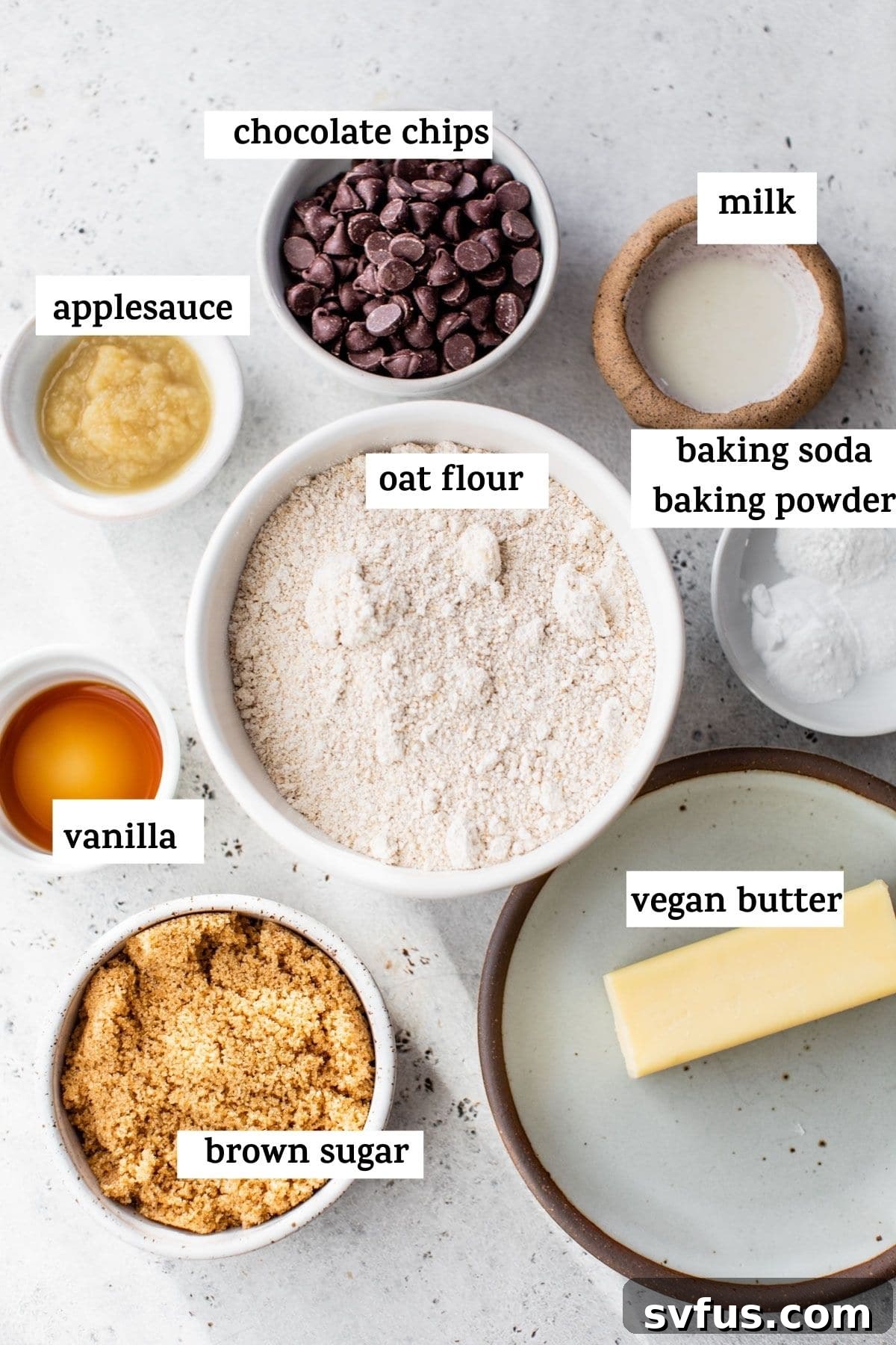 Ingredients laid out for making oat flour cookies, including vegan butter and sugar.