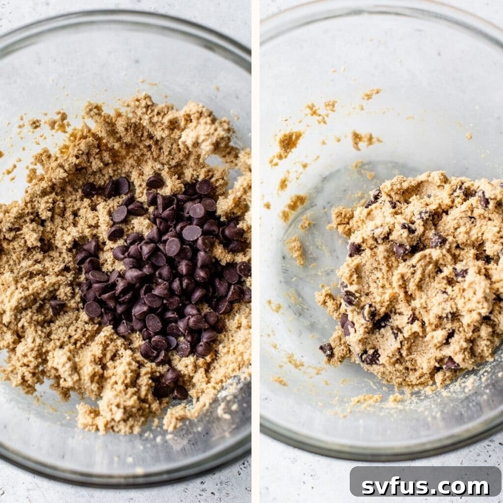 Rich cookie dough, studded with chocolate chips, in a large glass mixing bowl.