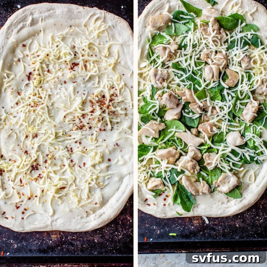 Unbaked pizza dough on a baking sheet, topped with shredded cheese, fresh spinach, and diced chicken, ready for the oven.
