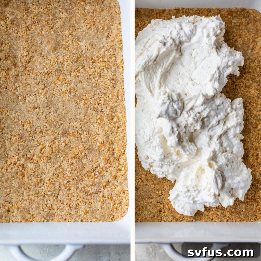 Spreading a thick layer of whipped cream cheese mixture over a golden pretzel crust in a baking dish.