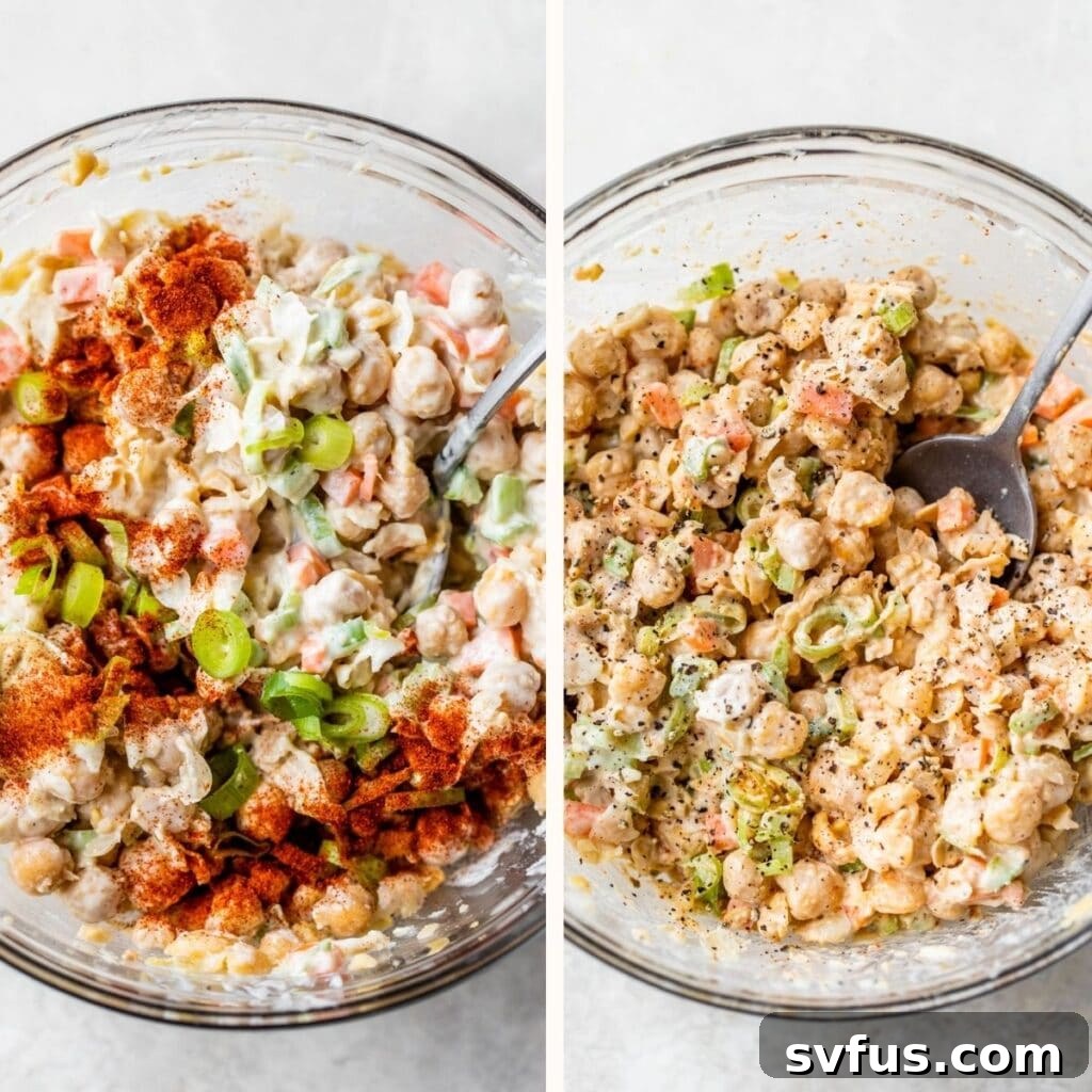 Smashed chickpeas mixed with various spices and a creamy dressing in a glass bowl, showcasing the vibrant colors and appealing texture.