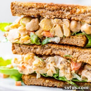 chickpea chicken salad on a sandwich on a plate