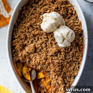 Gluten-Free Peach Crisp topped with vanilla ice cream