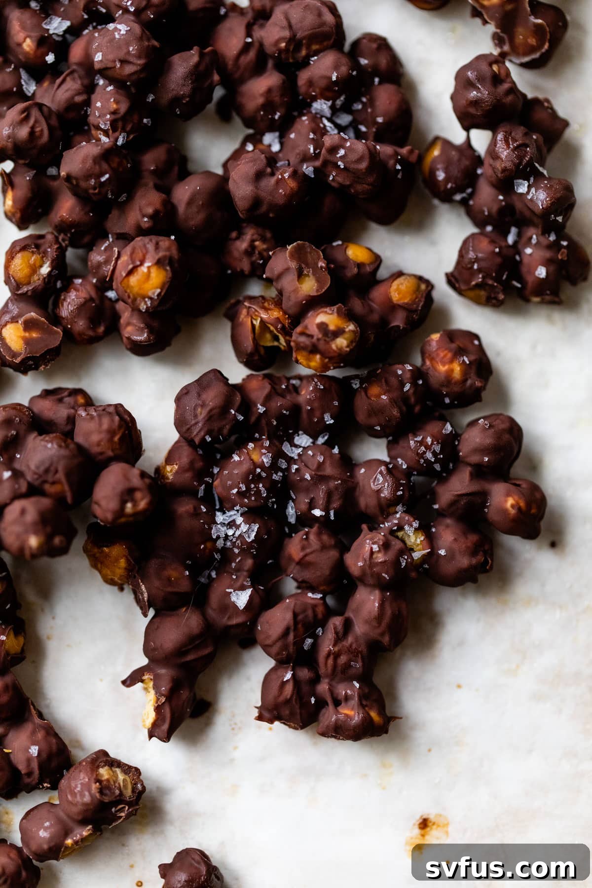 chocolate chickpeas sprinkled with sea salt, glistening under soft light