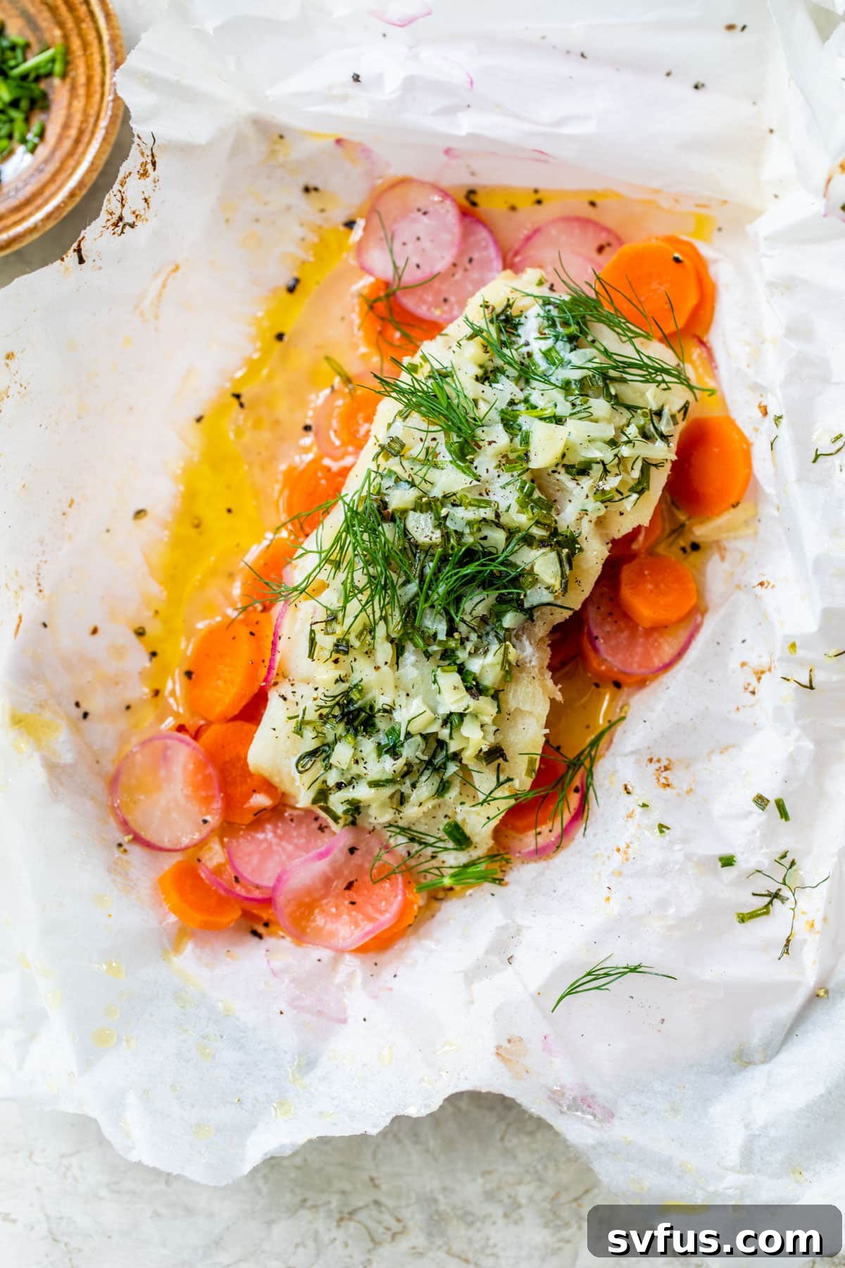 fish and vegetables in a parchment packet with melted butter