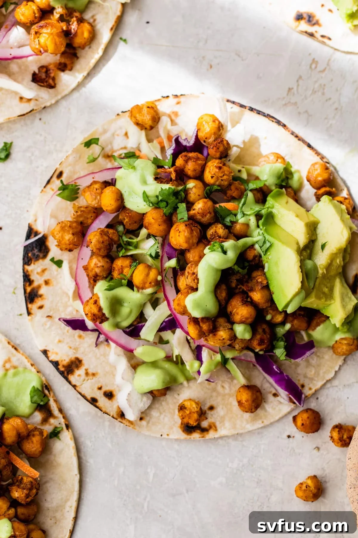 Crispy chickpea tacos with fresh avocado, red onion, and cilantro