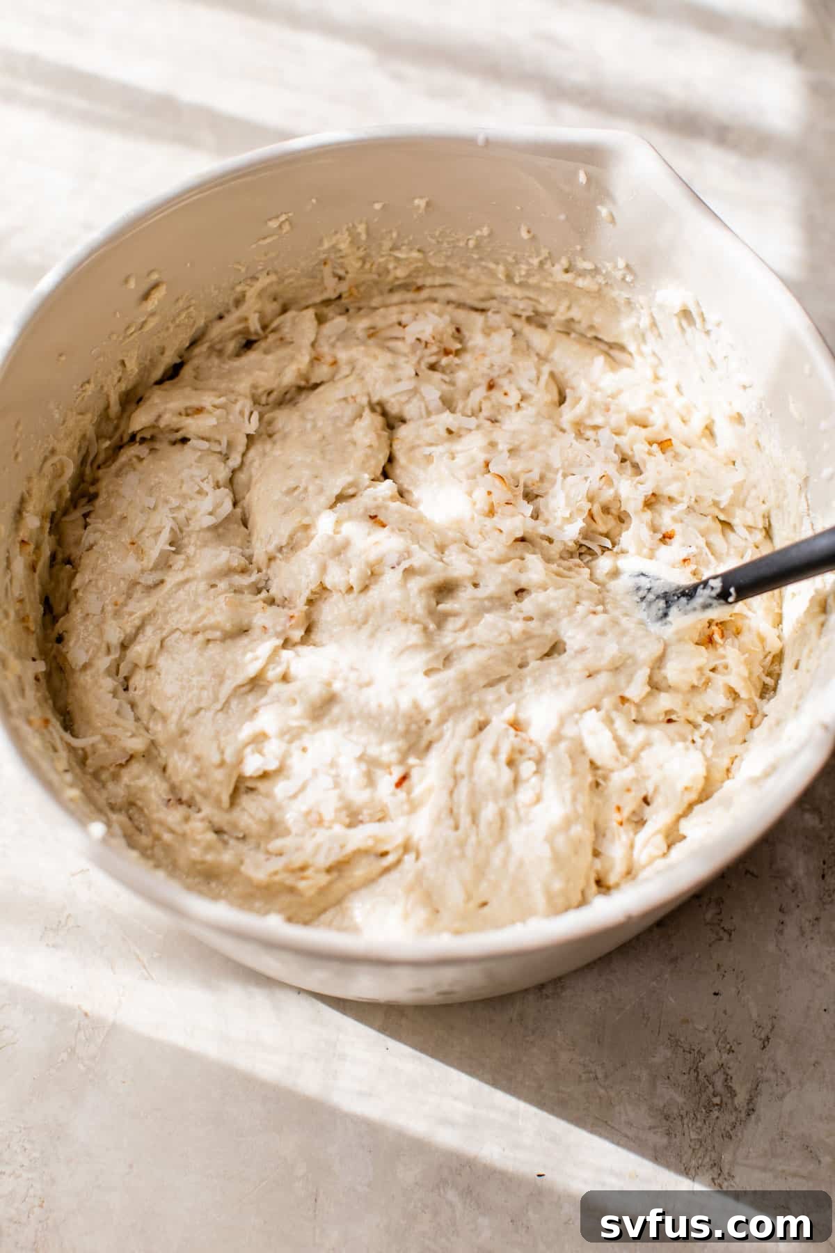 cupcake batter in a white mixing bowl