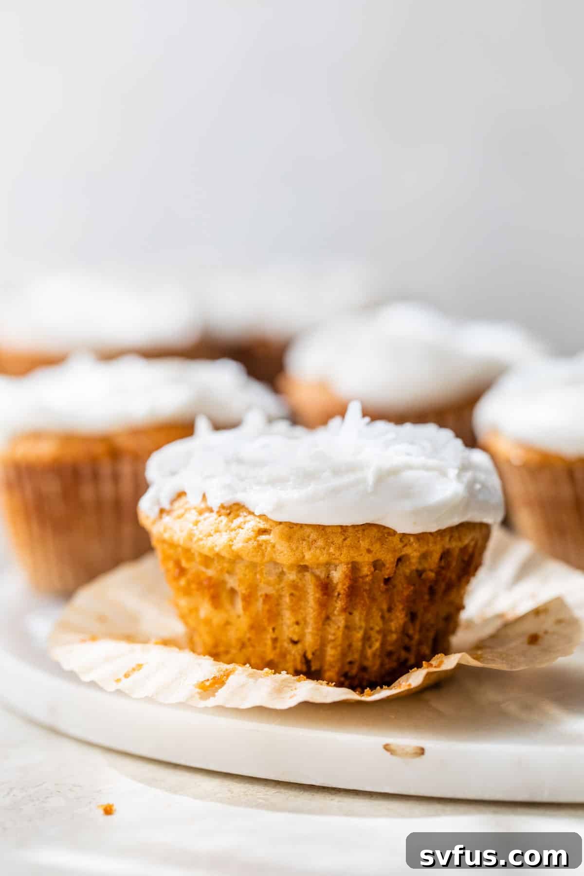 cupcakes with white icing and cupcake liners