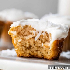 cupcake with white frosting with a bite taken out of it
