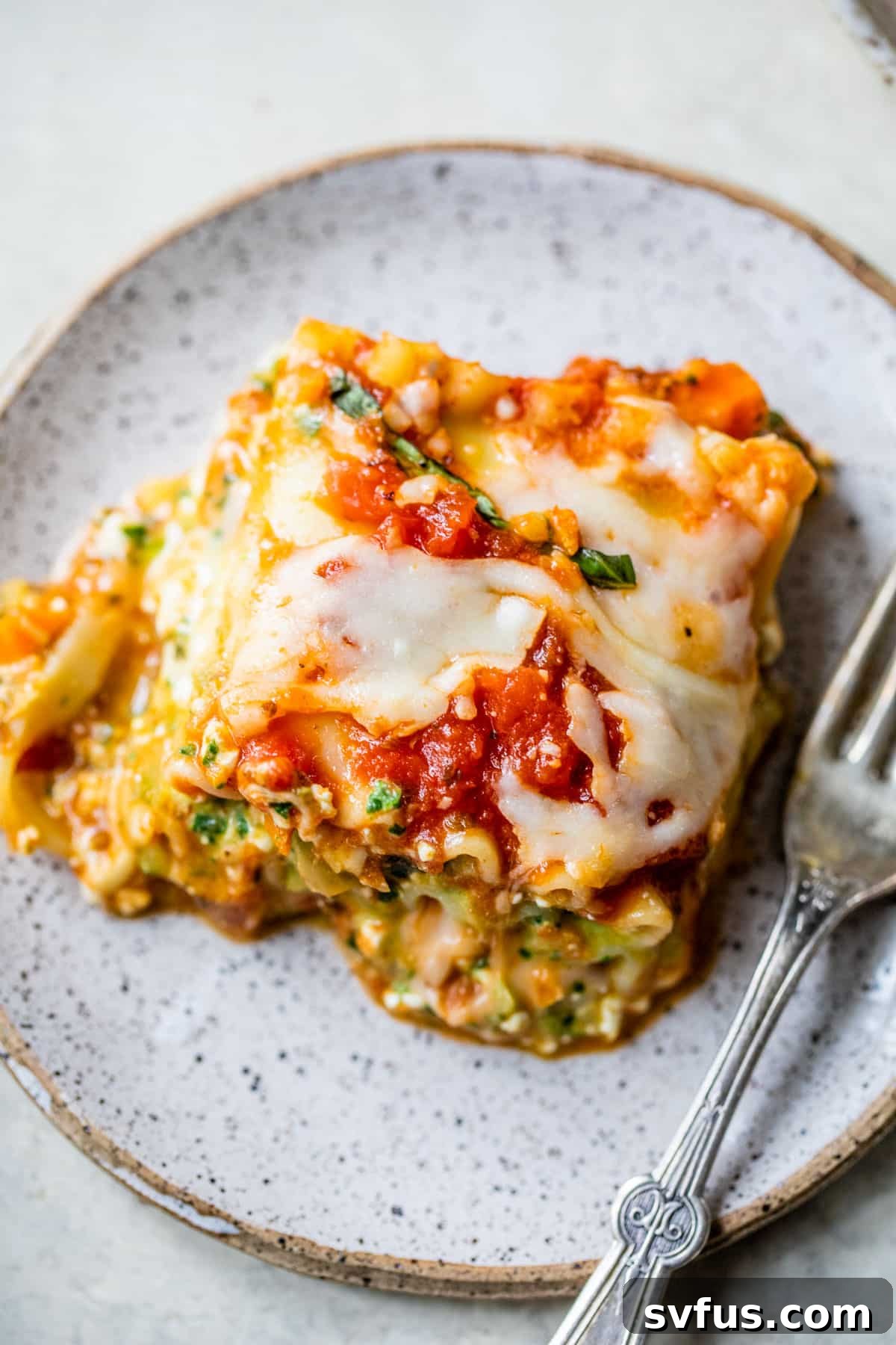 A close-up of a delectable slice of Cottage Cheese Lasagna on a plate, showcasing its rich, layered texture and melted cheese.
