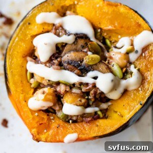 baked acorn squash stuffed with rice and drizzled with a white sauce