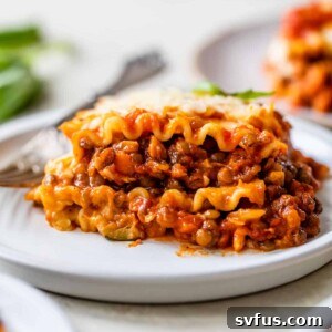 a piece of lasagna on a plate with a fork