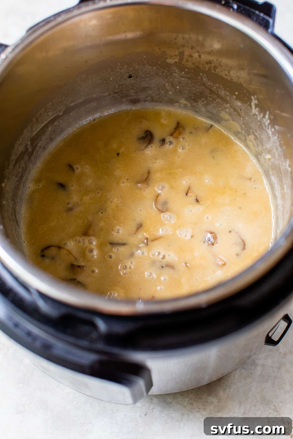 Rich, creamy mushroom gravy simmering in the Instant Pot.