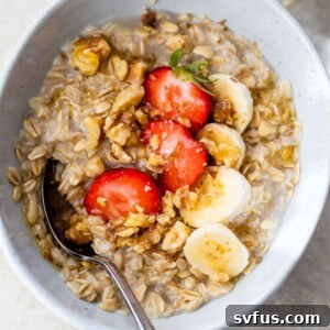oatmeal in a bowl with sliced strawberries and bananas