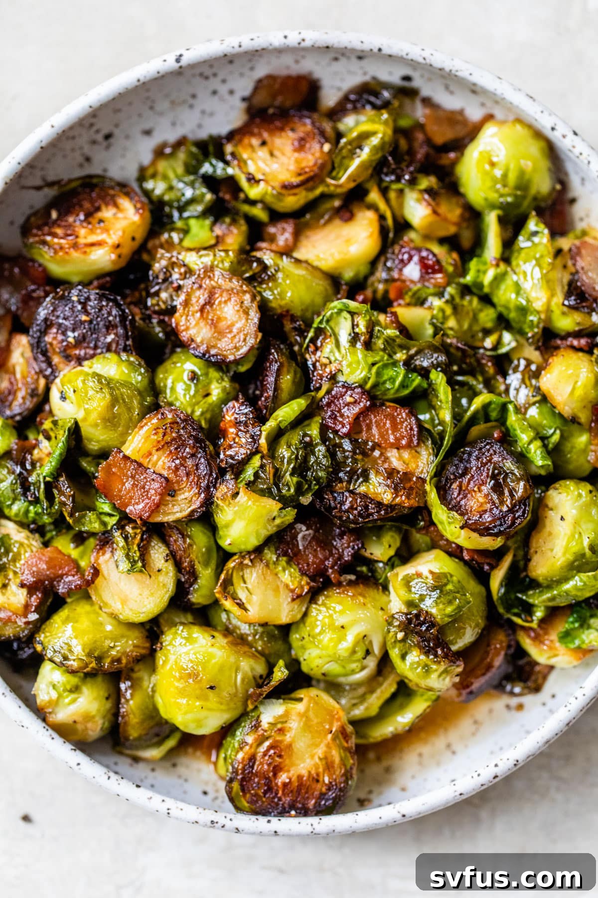 A beautifully presented bowl of roasted Brussels sprouts with crispy bacon, ready to be enjoyed