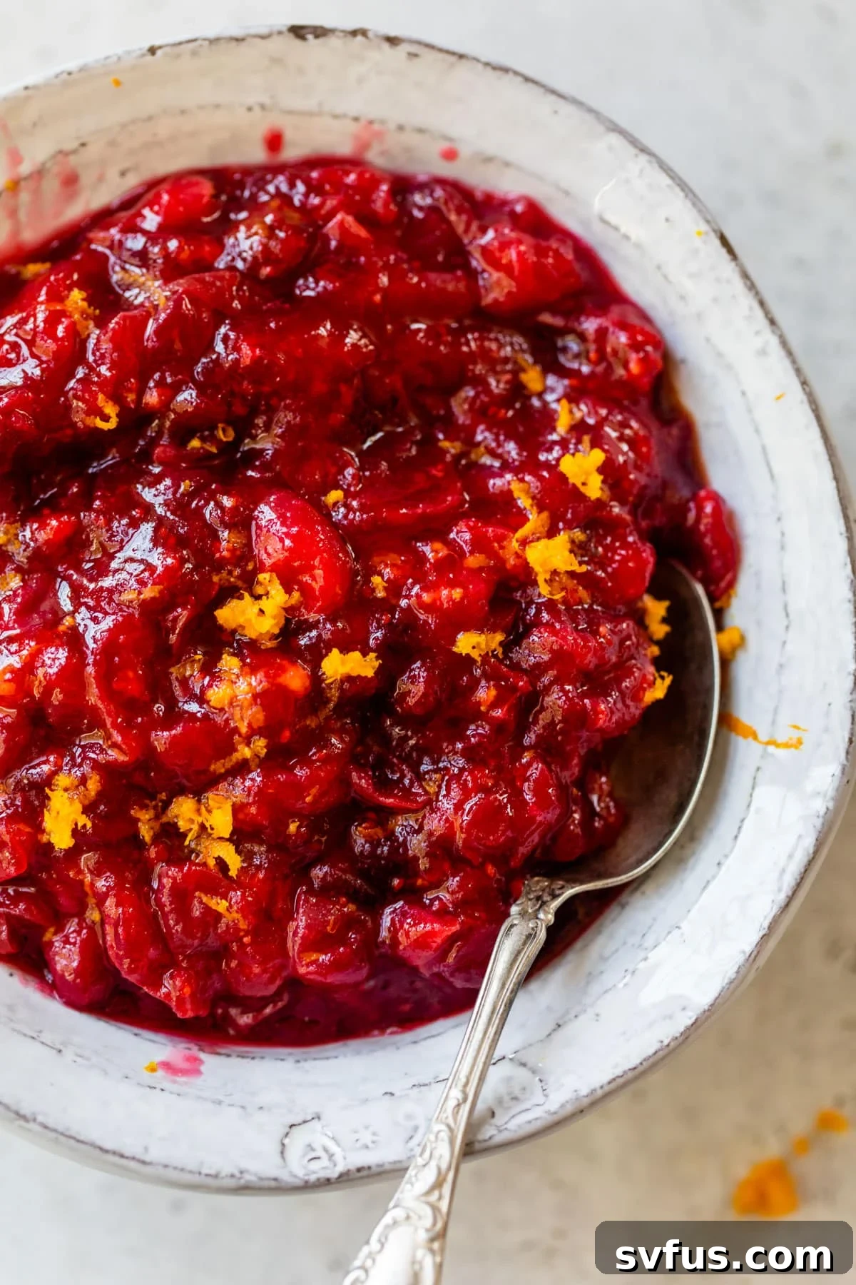 a bowl of cranberry sauce topped with orange zest