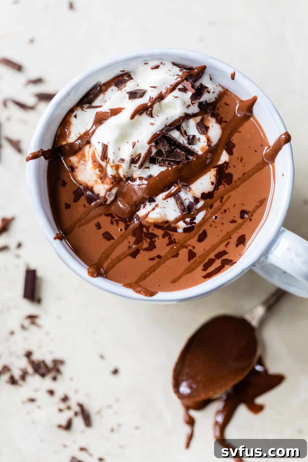 mug of hot chocolate with whipped cream and chopped chocolate