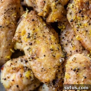 close up of chicken wings with lemon zest and black pepper