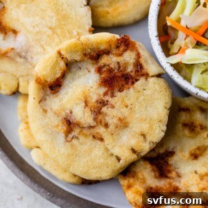 discs of cooked dough on a plate beside a small dish of cooked cabbage and carrots