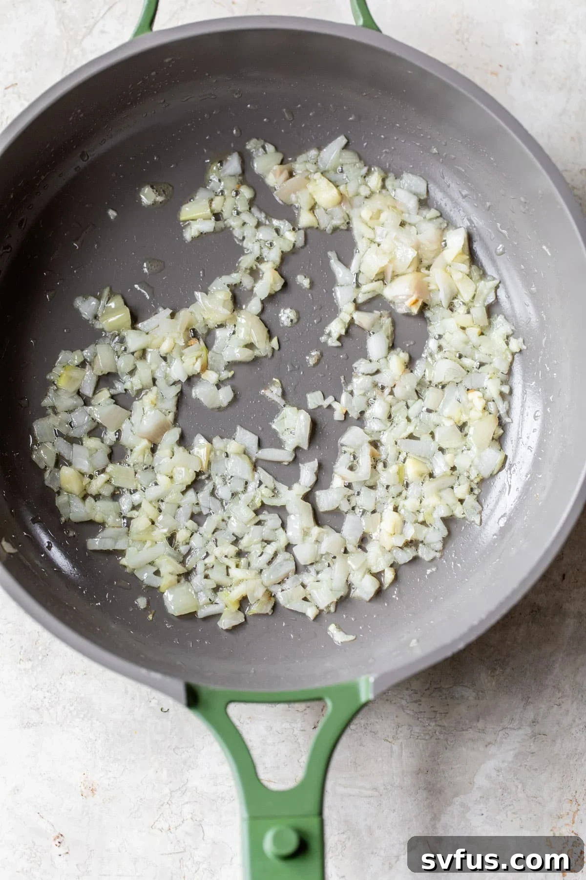 diced onion and garlic in a skillet