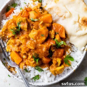 a bowl of white rice with chicken, bell peppers, cilantro, and naan