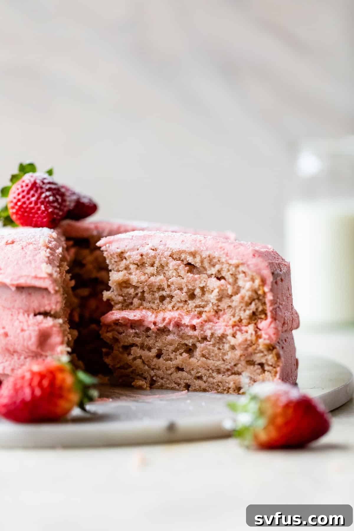 a picture of a two layer cake with a slice of cake being taken