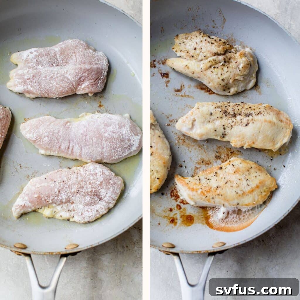 Two pieces of flour-coated chicken breast searing in a hot skillet, developing a golden crust.