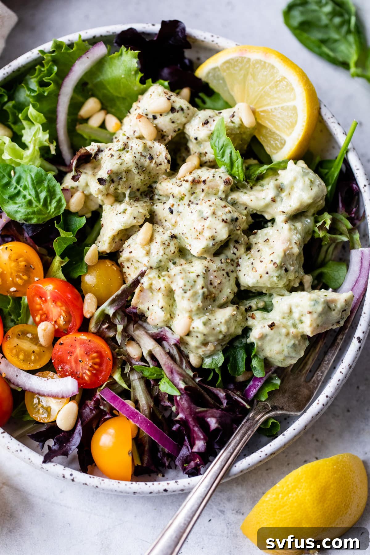 A close-up of fresh Pesto Chicken Salad, showcasing its vibrant colors and rich texture.