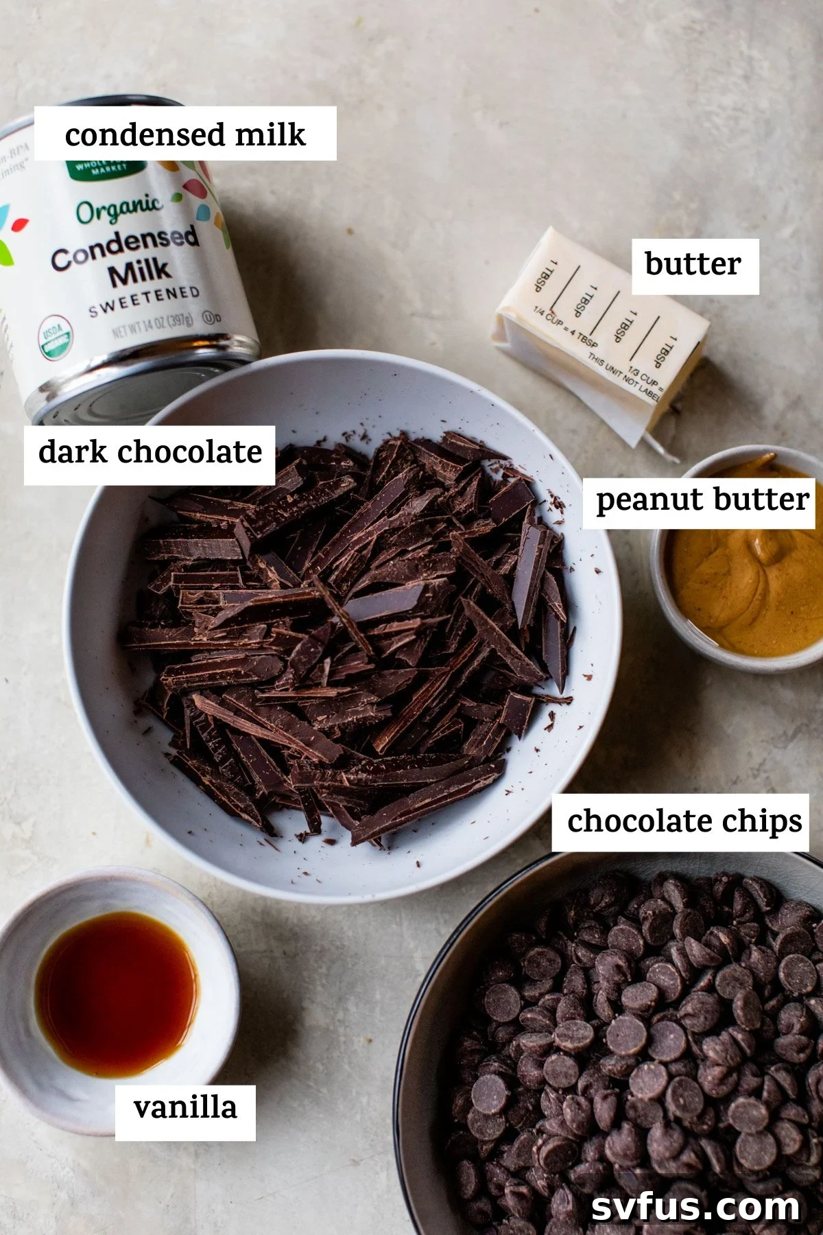 A selection of fudge ingredients laid out: sweetened condensed milk, sticks of butter, and various chocolates, ready for preparation.