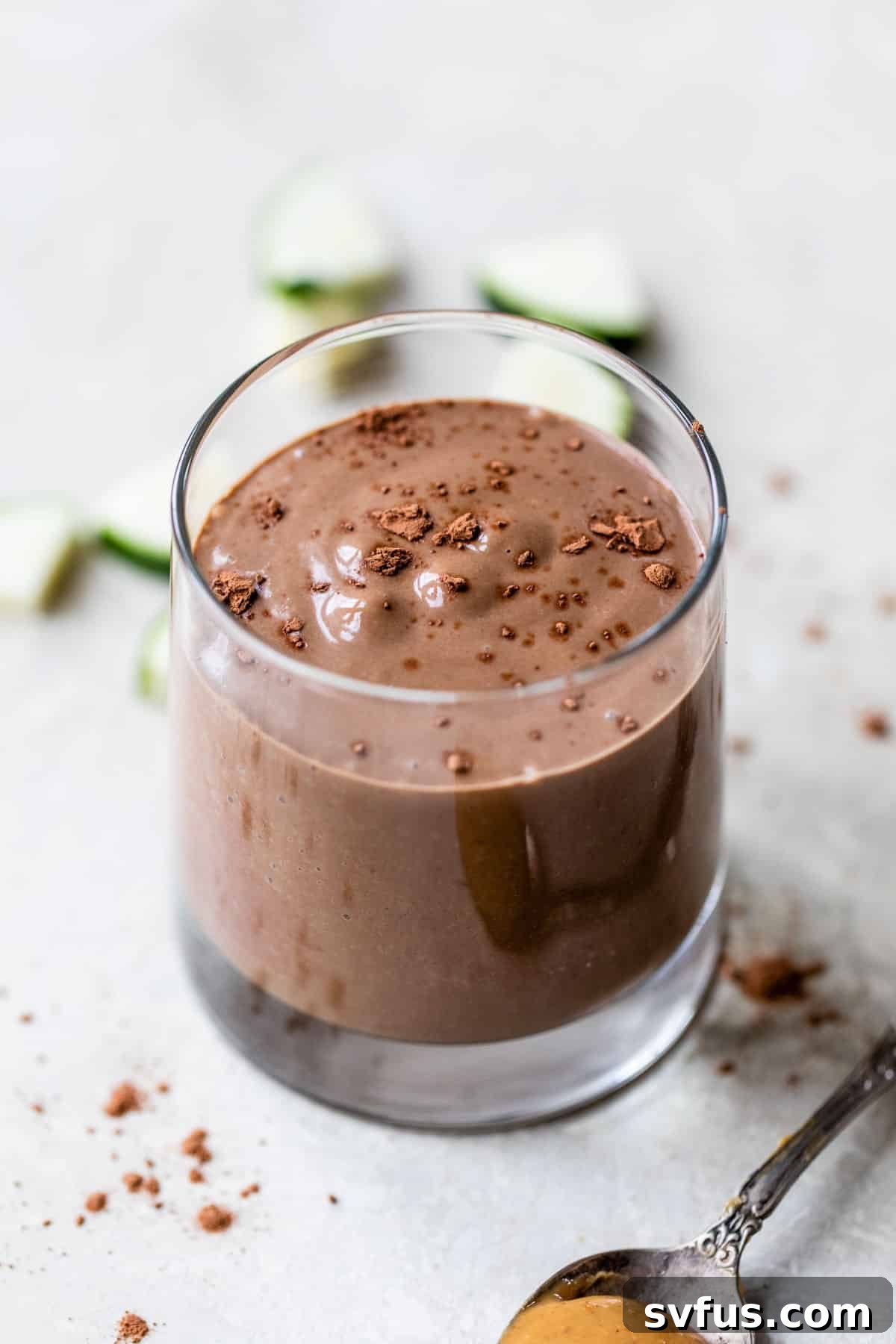 Close-up shot of a creamy chocolate zucchini smoothie in a glass, showcasing its smooth texture