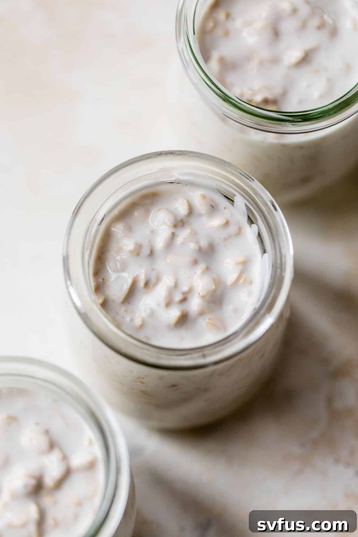 an overview shot of overnight oats just added to mason jars