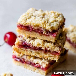 a stack of 3 dessert bars filled with cherries