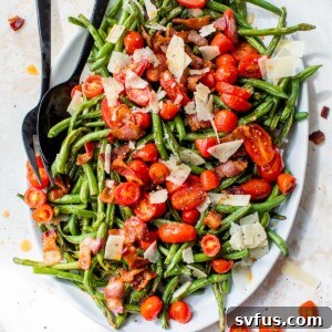 green beans, tomatoes, bacon, and shaved parmesan on an oval platter