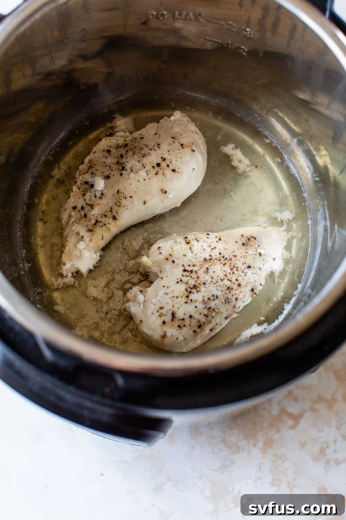 Chicken breasts cooking inside an Instant Pot, with the lid sealed.