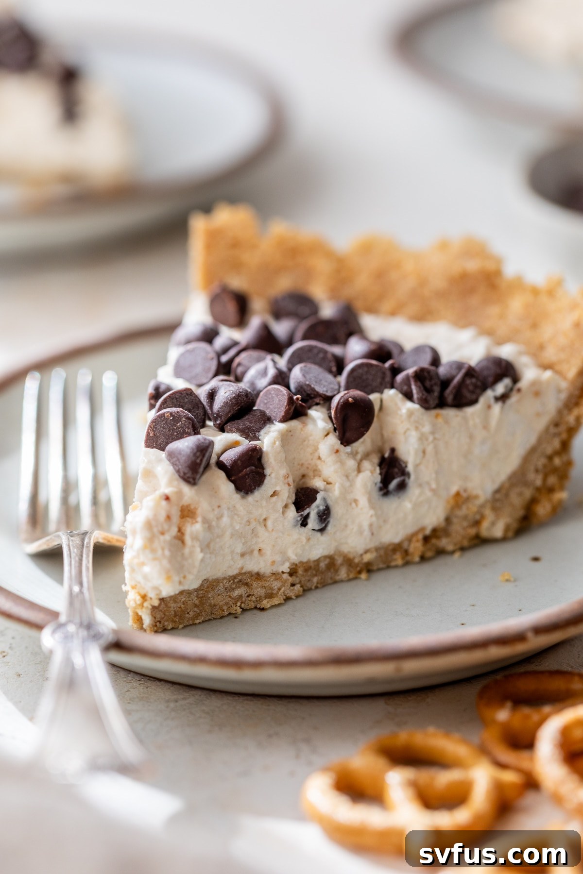 A delectable slice of peanut butter cottage cheese pie served on a white plate with a fork, ready to be enjoyed.