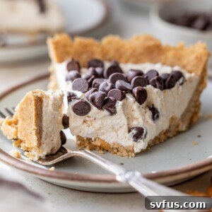 A delightful slice of peanut butter cottage cheese pie on a plate, with a bite taken, highlighting the creamy filling and crunchy pretzel crust.