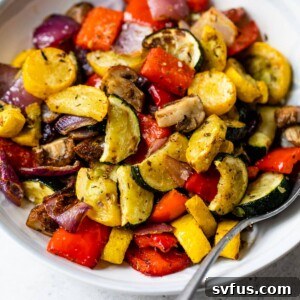 air fryer vegetables roasted in a bowl with a spoon