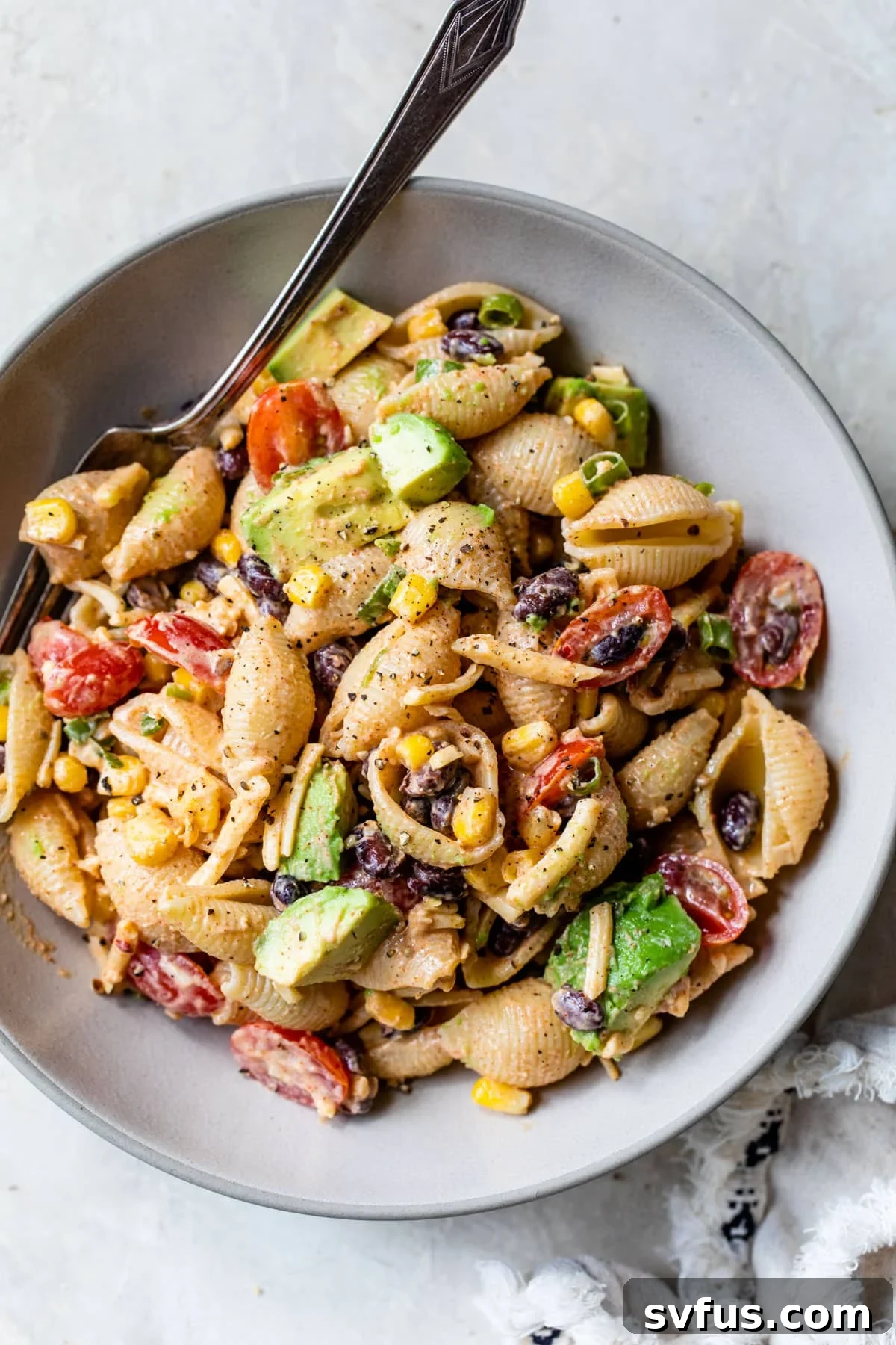 an overview of taco pasta salad in a bowl with a fork