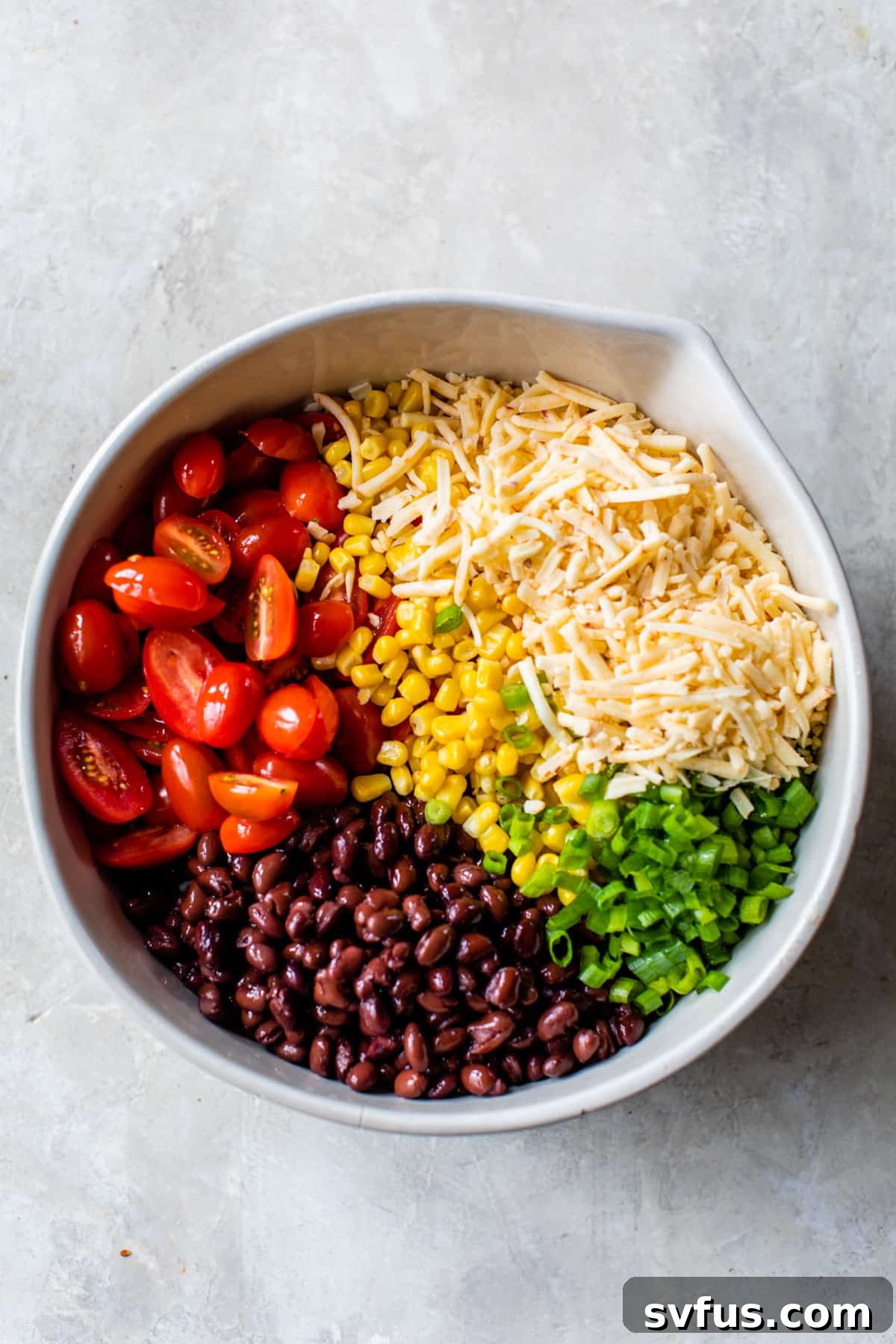 all of the ingredients in the taco pasta salad separated in a large bowl