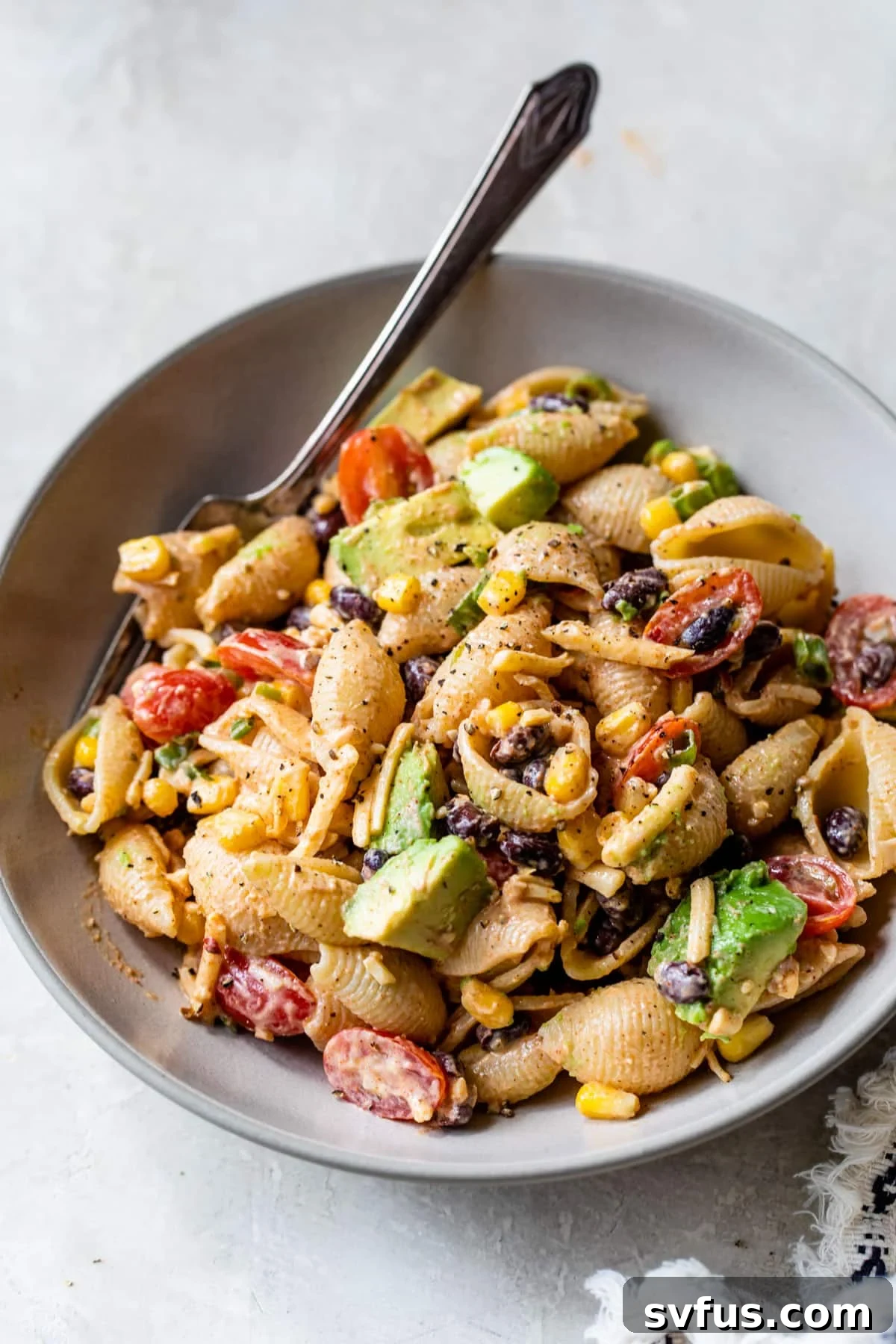 an overview of taco pasta salad in a bowl with a fork