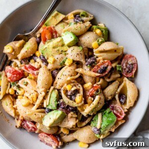 an overview of taco pasta salad in a bowl with a fork