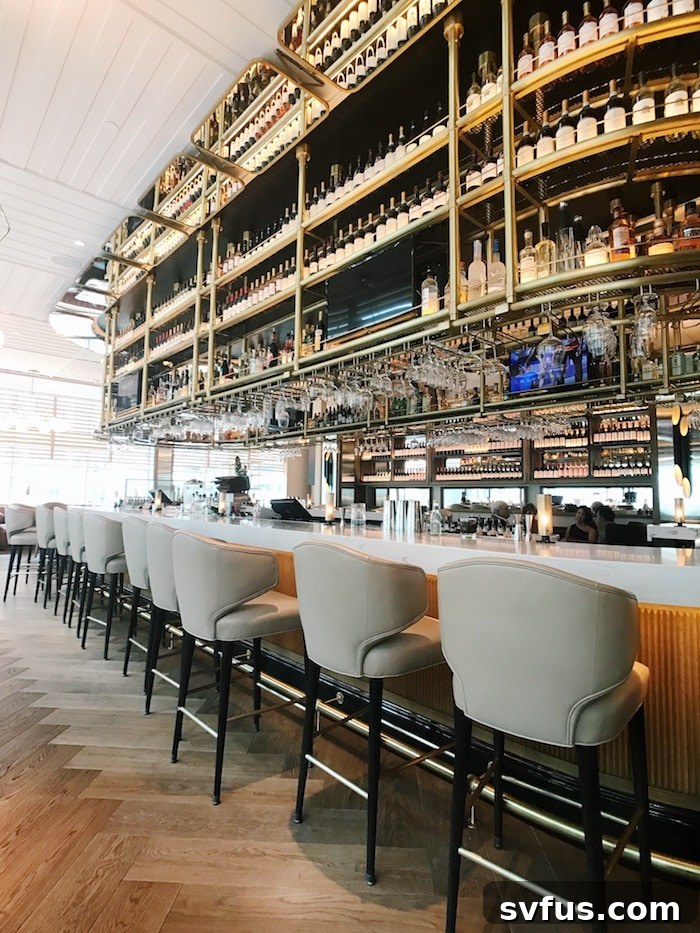 A stylish modern interior space with a striking light fixture and minimalist decor, suggesting a high-end restaurant or lounge area.