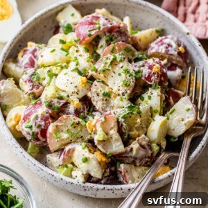healthy potato salad in a bowl with a fork