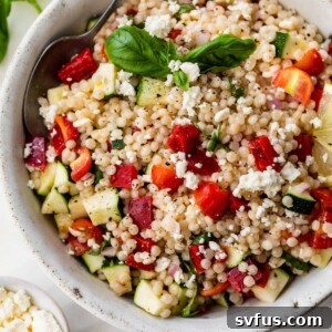 vegetable couscous inside of a bowl with a spoon