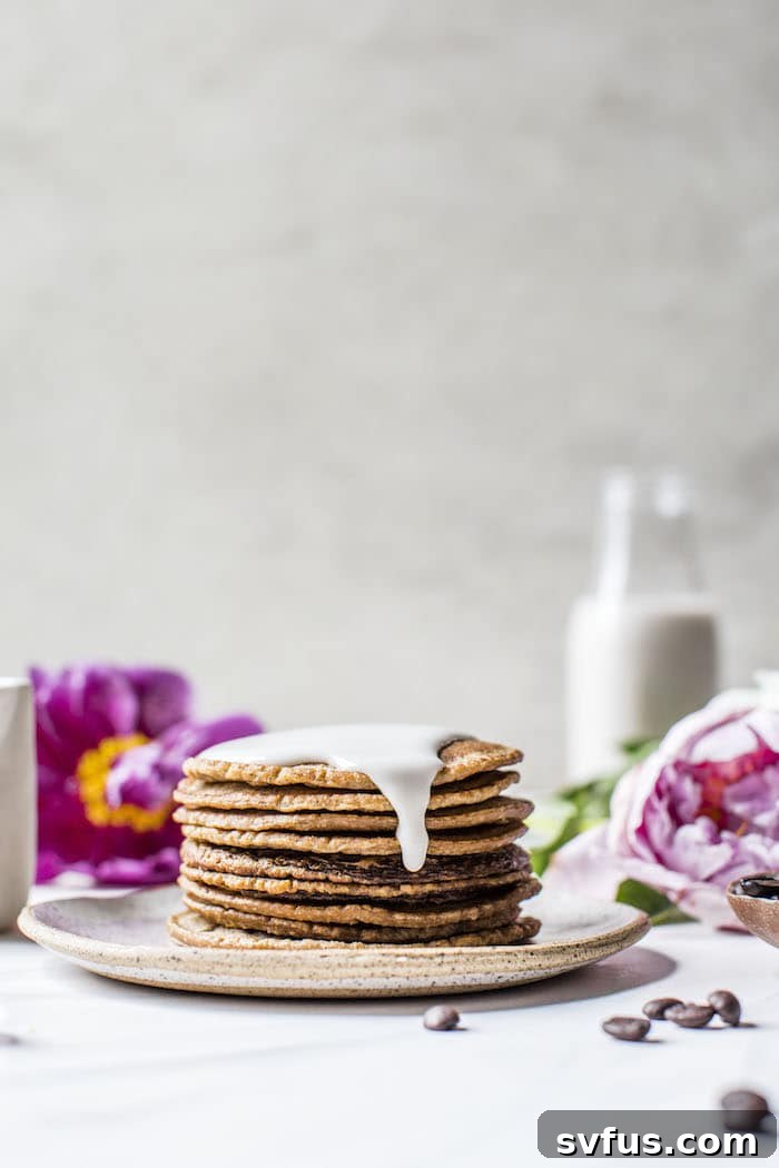 Artistically styled Lavender Espresso Pancakes with a cascade of sweet glaze, ready to be served.