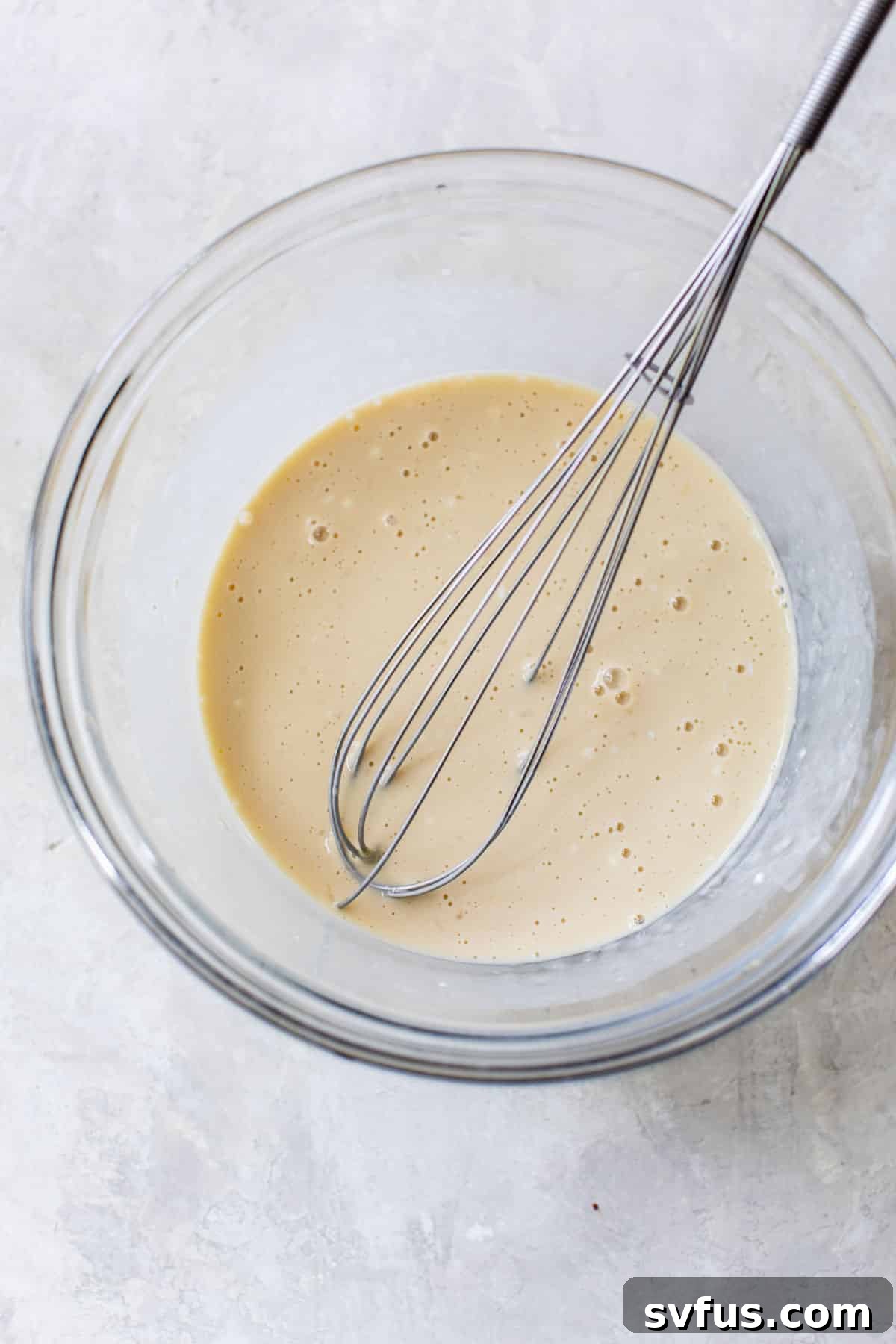 wet ingredients whisked together in a glass bowl
