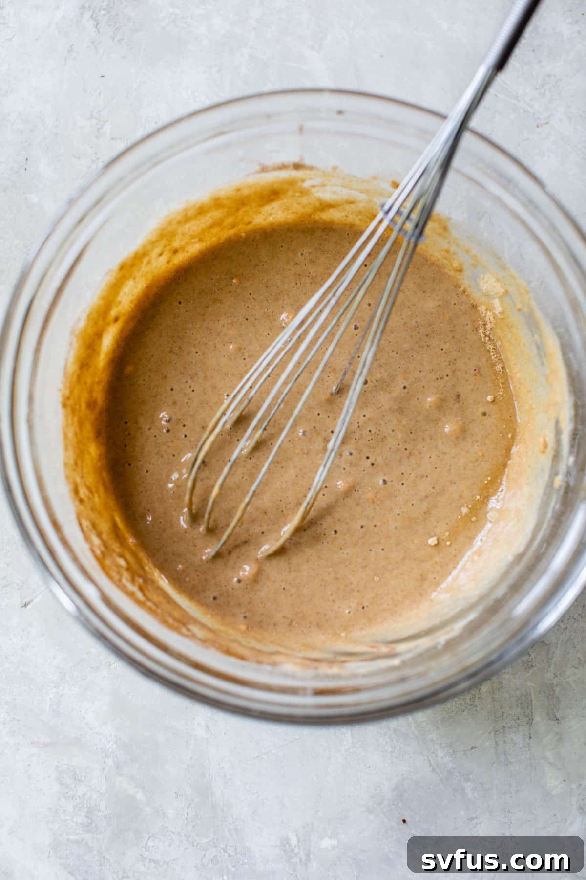 pancake batter whisked together in a glass bowl